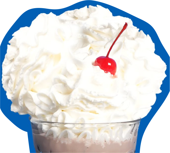 Glass of chocolate cream drink topped with a swirl of whipped cream and a red cherry against a blue background