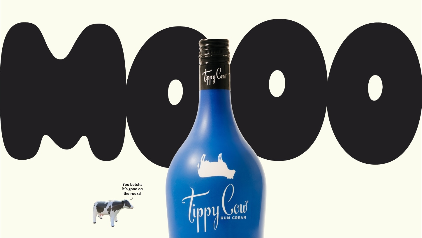 A blue bottle of Tippy Cow Vanilla Soft Serve Rum Cream with a white cow silhouette logo